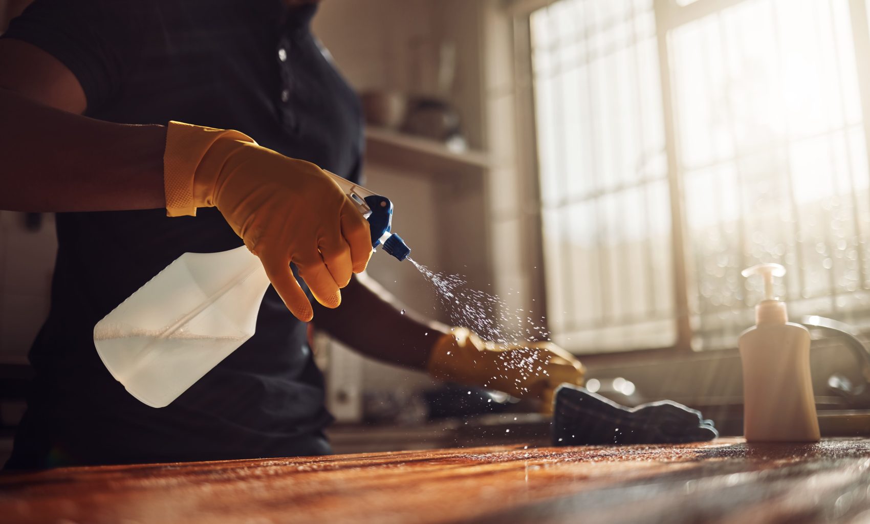 person-cleaning-a-wooden-surface-with-spray-bottle-2026-01-09-09-43-20-utc-2 (1)