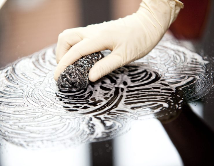 Woman cleansing ceramic glass cooktop